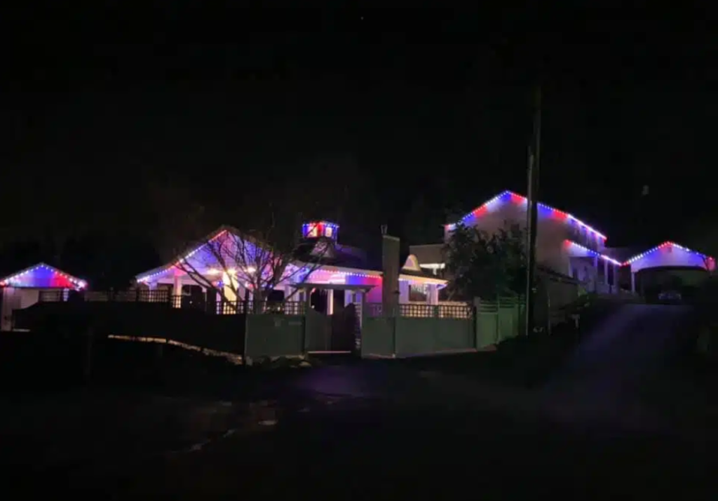 Home with permanent exterior lighting glowing red, white, and blue