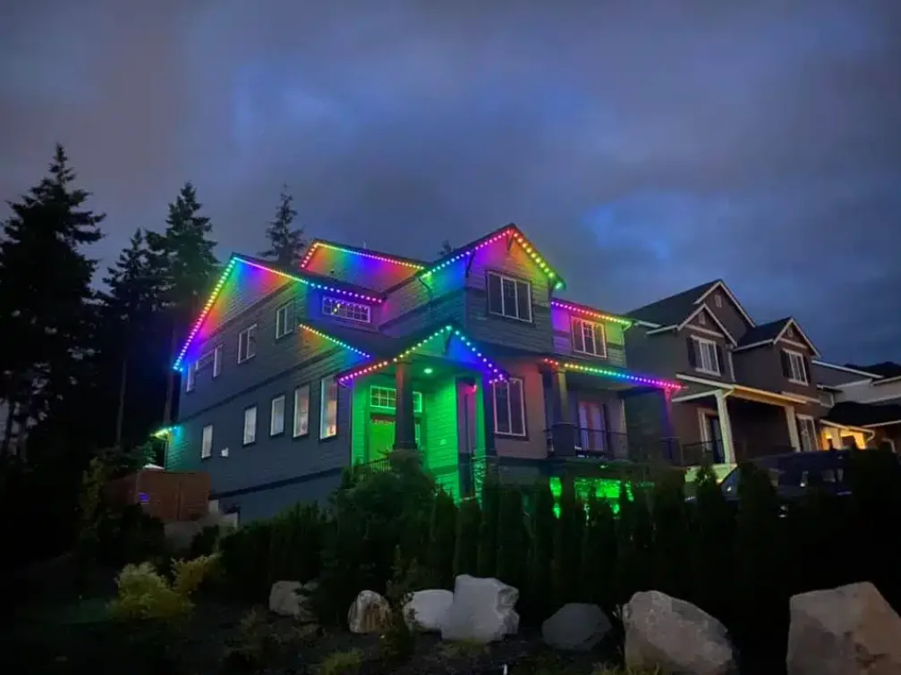 festive holiday lighting on the exterior of a large home