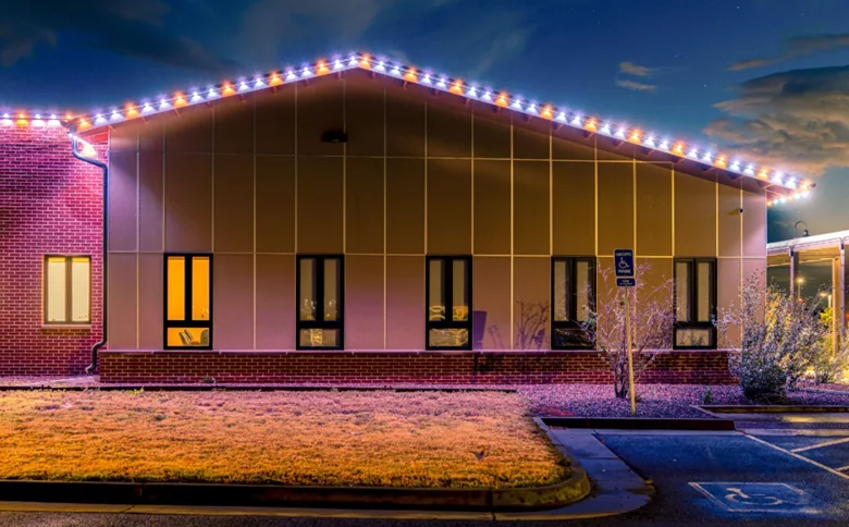 The outside of a commercial building with permanent lighting