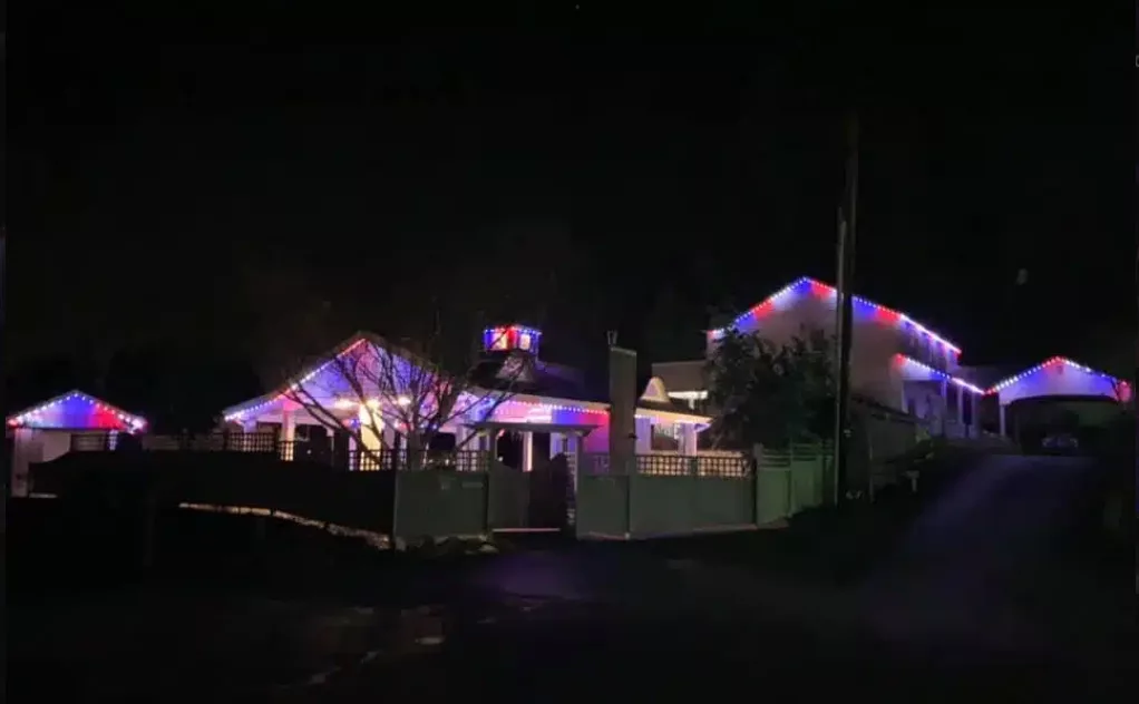 red, white, and blue lights on the exterior of a home, Christmas lights in Bellevue