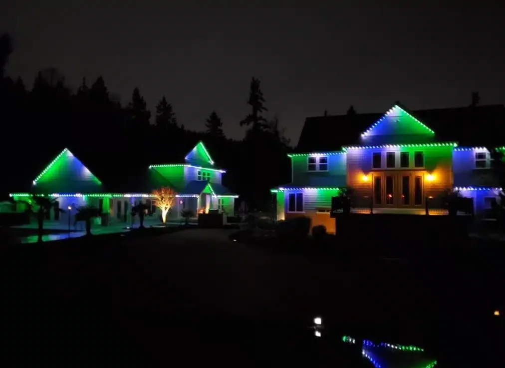 Bellevue Christmas Lights, Professional Christmas Lights installation near me on a large home that are green, blue, and white.